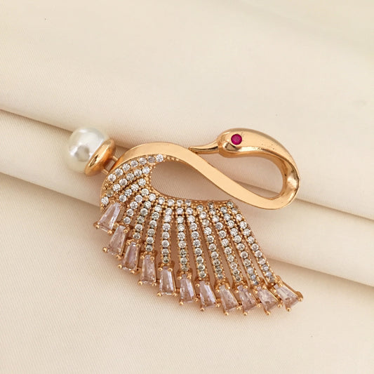 Gold swan-shaped brooch adorned with crystals and a pearl.