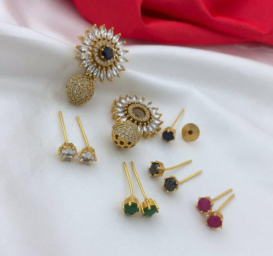 A set of interchangeable American diamond earrings with various gemstone options including green, red, black, and clear stones.