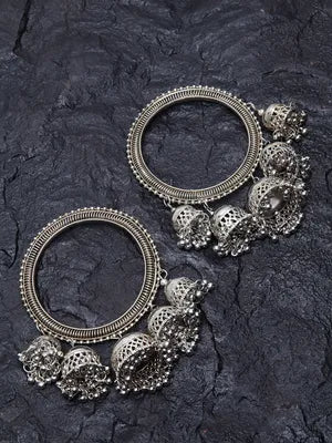 Two handcrafted oxidized bracelets with intricate designs and dangling elements.